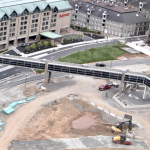 A web cam photo of the southern end of the Cogswell interchange, under construction. Between the Marriott Hotel and the Morse Tea Building is the new park area, with green grass and new trees planted. Construction continues to the north.